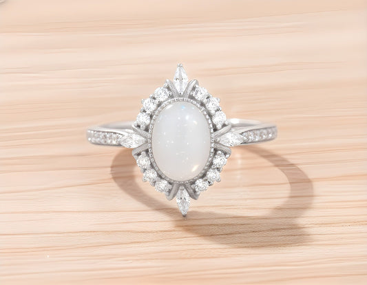 Silver ring with a central breastmilk gemstone on a wooden surface. 
Milky Way Spirit & Soul Keepsakes