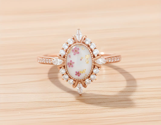 Rose gold plated ring with a central breastmilk gemstone on a wooden surface.
Milky Way Spirit & Soul Keepsakes