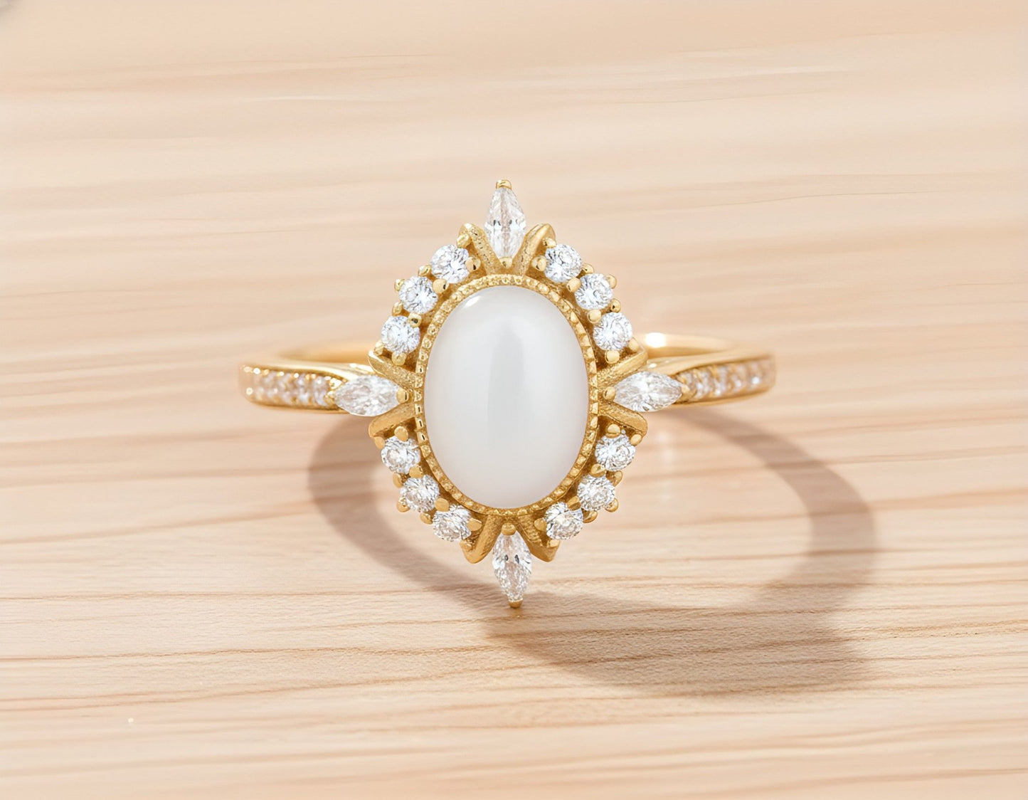 Gold ring with a central breastmilk gemstone on a wooden surface. 
Milky Way Spirit & Soul Keepsakes 