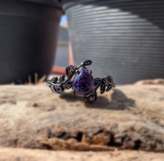 Lilith's Embrace ring. Sterling silver, plated with black rhodium with amethyst accent stones. Bloodstone center stone is purple with purple crushed opal.