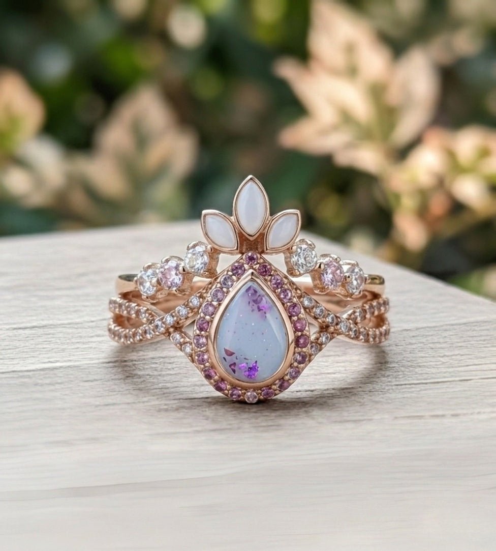 Luxury ring with gemstones and milk stones on a wooden surface with a blurred natural background.
