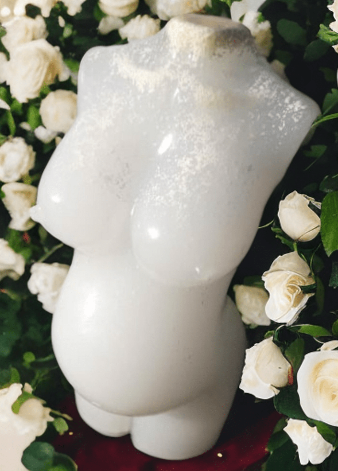 Pregnancy bust. Made with breastmilk with a white flowery background.